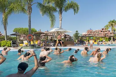 a group of people in the swimming pool at a resort at Elba Costa Ballena Beach & Thalasso Resort in Costa Ballena