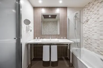 a white bathroom with a sink and a shower at Elba Costa Ballena Beach & Thalasso Resort in Costa Ballena