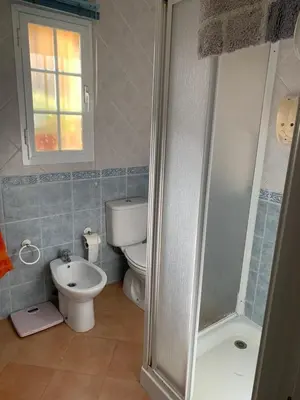 a bathroom with a shower and a toilet and a sink at La Bilbaina con Piscina, Jardin y Parking Exclusivo 10 in Chiclana de la Frontera