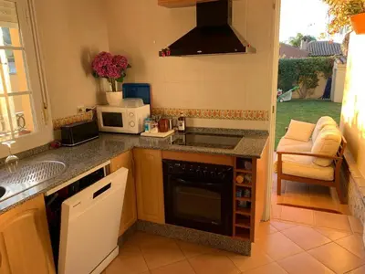 a kitchen with a sink and a stove top oven at La Bilbaina con Piscina, Jardin y Parking Exclusivo 10 in Chiclana de la Frontera