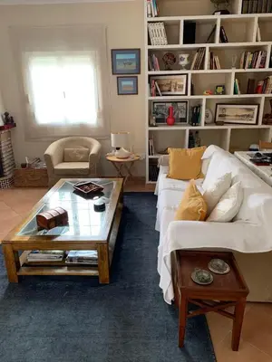 a living room with a white couch and a coffee table at La Bilbaina con Piscina, Jardin y Parking Exclusivo 10 in Chiclana de la Frontera