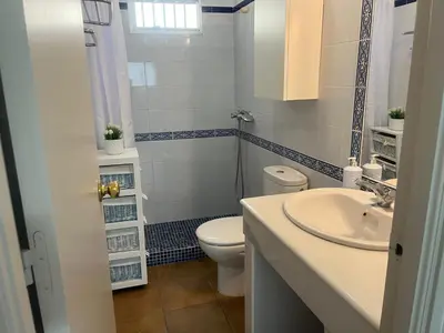 a bathroom with a toilet and a sink at Mi Paraiso in Sanlúcar de Barrameda