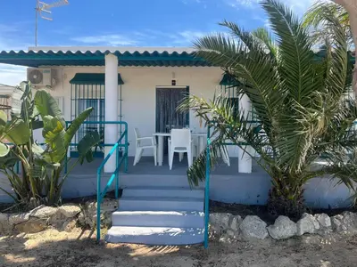 a house with a staircase leading to the front door at Mi Paraiso in Sanlúcar de Barrameda