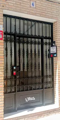 a black gate in a window of a building at Bienvenidos a San Miguel in Jerez de la Frontera