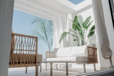 a living room with two chairs and a couch at AZURE - Ático dúplex in Chipiona
