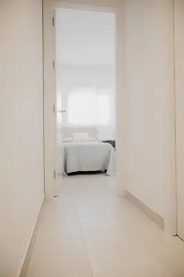 an open door to a bedroom with a bed at AZURE - Ático dúplex in Chipiona