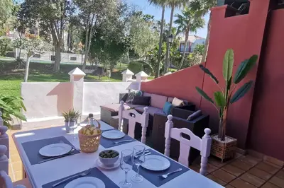 a table with plates on it on a patio at Kalma Vivienda vacacional la barrosa Chiclana Cadiz in Chiclana de la Frontera