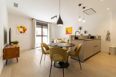 a kitchen and dining room with a table and chairs at Allo Apartments San Clemente Parking Piscina Centro 2 Habitaciones in Jerez de la Frontera