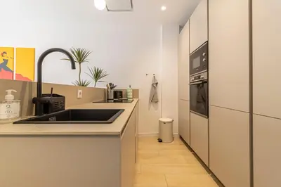 a kitchen with a sink and a stove at Allo Apartments San Clemente Parking Piscina Centro 2 Habitaciones in Jerez de la Frontera