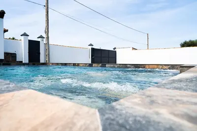 a swimming pool with water in the middle at Domus Gades in Chiclana de la Frontera