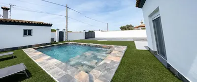 a swimming pool in the backyard of a house at Domus Gades in Chiclana de la Frontera