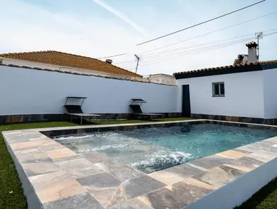 a swimming pool in the backyard of a house at Domus Gades in Chiclana de la Frontera