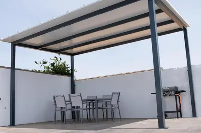 a pavilion with a table and chairs under it at Domus Gades in Chiclana de la Frontera
