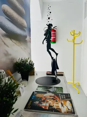 a figurine of a woman on a desk with a candle at SOTAVENTO Salmarina in Sanlúcar de Barrameda