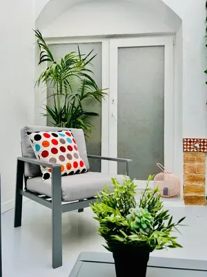 a chair with a polka dot pillow and plants at SOTAVENTO Salmarina in Sanlúcar de Barrameda
