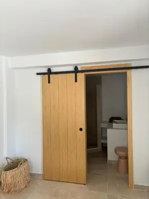 a wooden door in a room with a bathroom at Casa Santos Arcos vistas y parking privado in Arcos de la Frontera