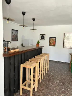 a bar with a row of stools in a room at Casa Santos Arcos vistas y parking privado in Arcos de la Frontera