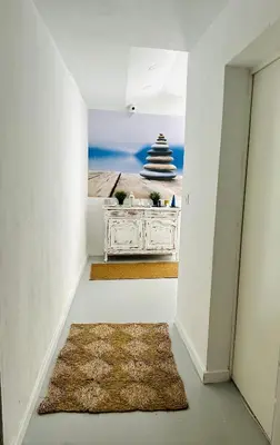 a hallway with a table with a picture of the ocean at Sotavento Malandar in Sanlúcar de Barrameda