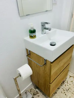 a bathroom with a white sink and a mirror at Sotavento Malandar in Sanlúcar de Barrameda