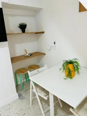 a white dining room with a table and chairs at Sotavento Malandar in Sanlúcar de Barrameda