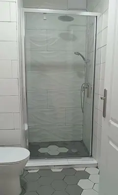 a glass shower in a bathroom with a toilet at Apartamento, Plaza las Infantas in Sanlúcar de Barrameda