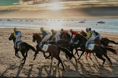 a group of people riding horses on the beach at Apartamento, Plaza las Infantas in Sanlúcar de Barrameda