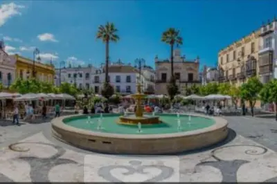 a large fountain in a square in a city at Apartamento, Plaza las Infantas in Sanlúcar de Barrameda