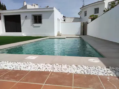 a swimming pool in the backyard of a house at CHICLANA&DISFRUTA in Chiclana de la Frontera