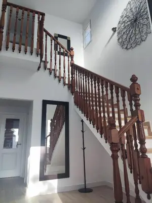 a wooden staircase with a mirror in a room at CHICLANA&DISFRUTA in Chiclana de la Frontera