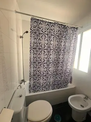 a bathroom with a toilet and a shower curtain at PISO CENTRO HISTÓRICO 3 DORMITORIOS in Jerez de la Frontera