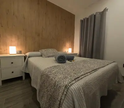 a bedroom with a bed with a hat on it at El rincon de Carmen in Jerez de la Frontera