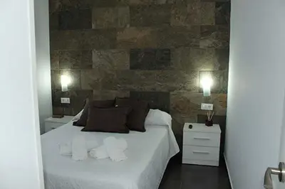 a bedroom with a bed with two towels on it at Finca La Garrocha in Conil de la Frontera