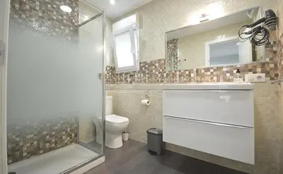 a bathroom with a shower and a toilet and a sink at Finca La Garrocha in Conil de la Frontera
