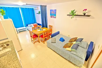 a living room with a couch and a table at Mercado Abastos Central Apartment in El Puerto de Santa María