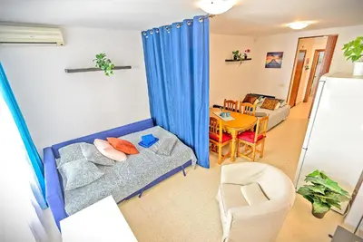 a living room with a couch and a table at Mercado Abastos Central Apartment in El Puerto de Santa María