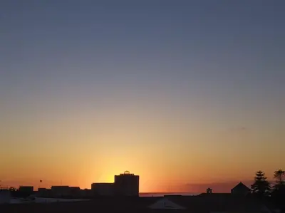 a sunset over a city with buildings in the foreground at Fortes holidays in Sanlúcar de Barrameda