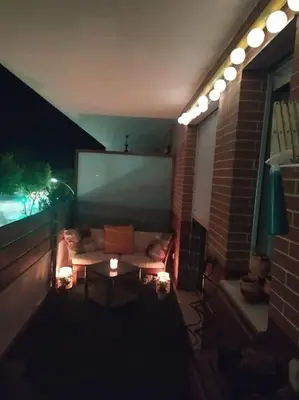 a patio at night with a couch and a table at Fortes holidays in Sanlúcar de Barrameda