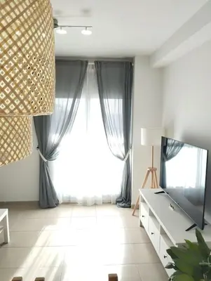 a living room with a large window and a television at Fortes holidays in Sanlúcar de Barrameda