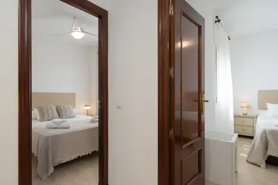 a mirror in a room with a bed at Maravilloso apartamento junto al mar a 5 km Cadiz in Puerto Real