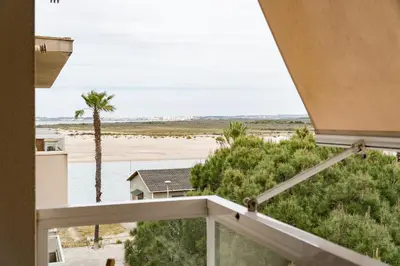 a balcony with a view of the beach at Maravilloso apartamento junto al mar a 5 km Cadiz in Puerto Real
