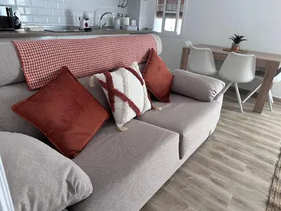 a couch with pillows on it in a living room at TORREJÓN in Jerez de la Frontera