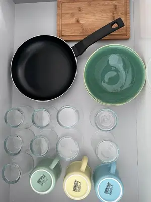 a frying pan and a pan and containers on a table at TORREJÓN in Jerez de la Frontera