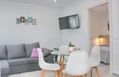 a living room with a couch and a table and chairs at Casa El Rellano in Hozanejos
