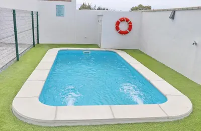 a swimming pool on the side of a building at Casa El Rellano in Hozanejos