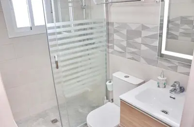 a bathroom with a shower and a toilet and a sink at Casa El Rellano in Hozanejos