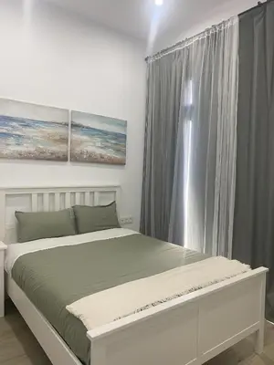 a bedroom with a large bed and a window at Apartamento Barrosa Beach in Chiclana de la Frontera