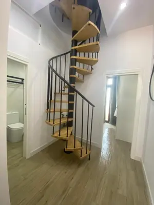 a spiral staircase in a room with a bathroom at Apartamento Barrosa Beach in Chiclana de la Frontera