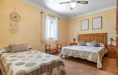 a bedroom with two beds and a window at Nice Home In Chiclana De La Fronter in Chiclana de la Frontera