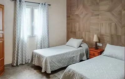 a bedroom with two beds and a window at Nice Home In Chiclana De La Fronter in Chiclana de la Frontera