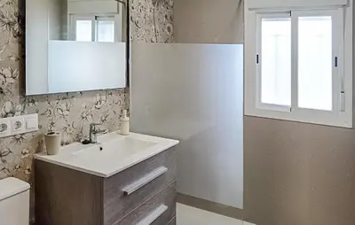 a bathroom with a sink and a mirror at Nice Home In Chiclana De La Fronter in Chiclana de la Frontera